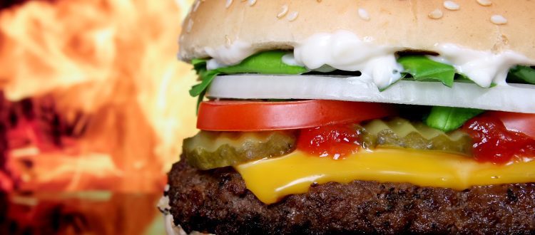 A cheeseburger beside a sleek limousine, symbolizing the collision of National Cheeseburger Day deals and Chicago's luxury car services in 2023.