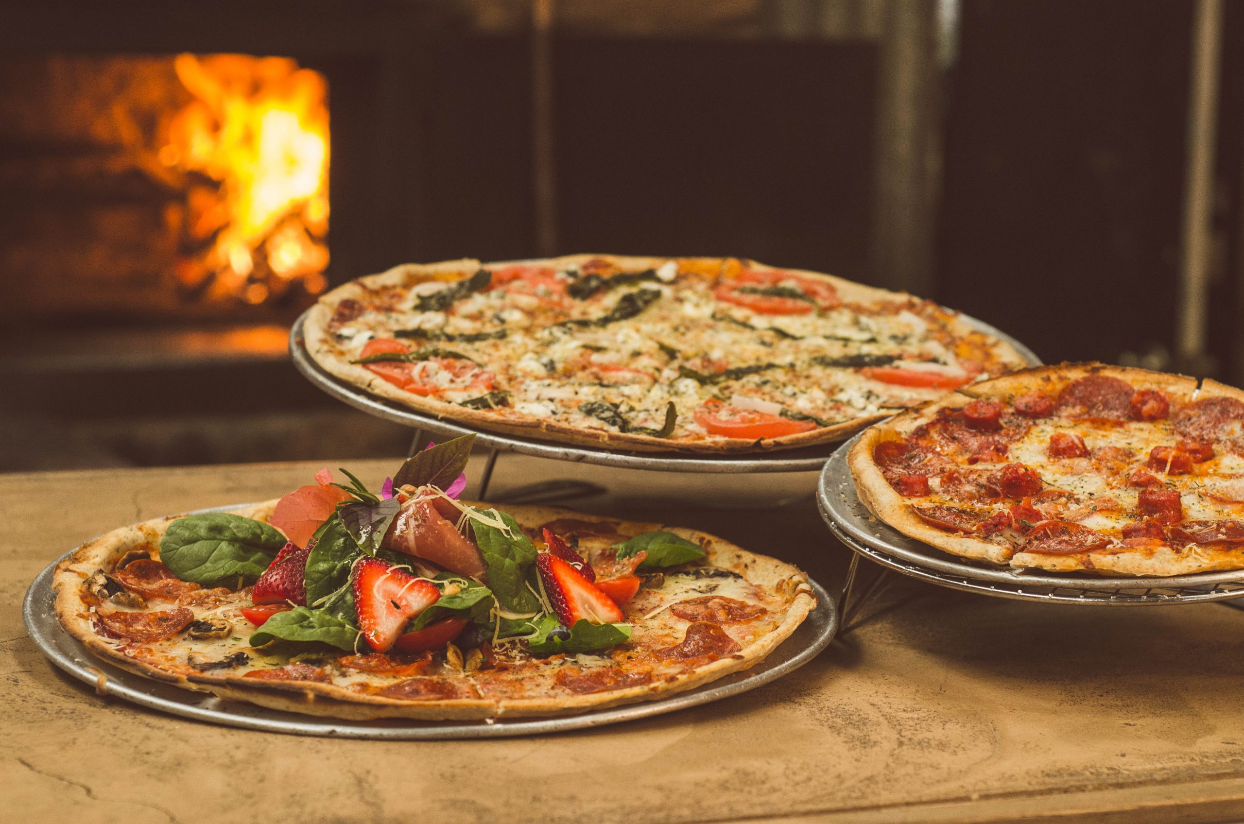 A delicious spread at Spacca Napoli Pizzeria, showcasing the renowned Neapolitan-style pizzas that mark Chicago's culinary excellence on the global map.